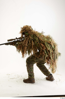 Brandon Davis in Ghillie suit Pose crouching aiming gun crouching…